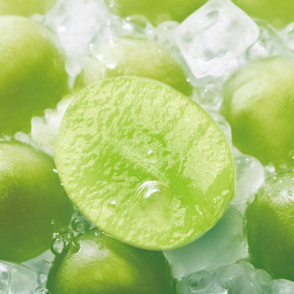 RELX POD PRO 2 Green Grape Ice pods placed with fresh green grapes and icy elements, showcasing their crisp and sweet essence.